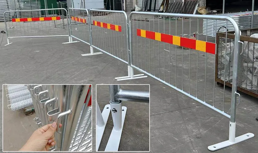 Galvanized steel crowd control barriers connected in a line with red reflective stripes